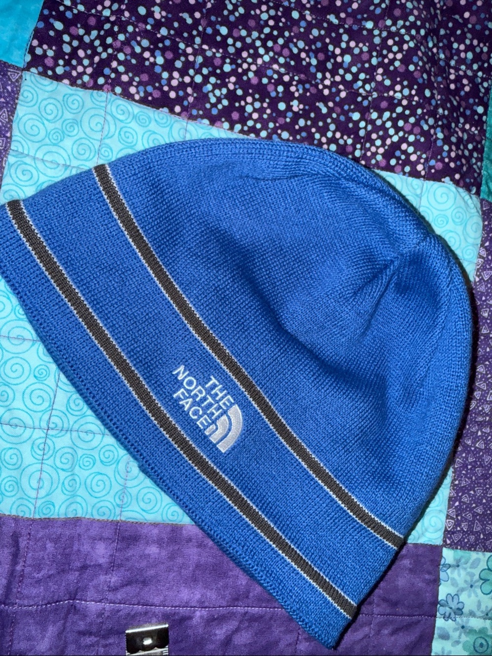 The North Face Blue beanie hat with ear band fleece accent stripes & embroidered